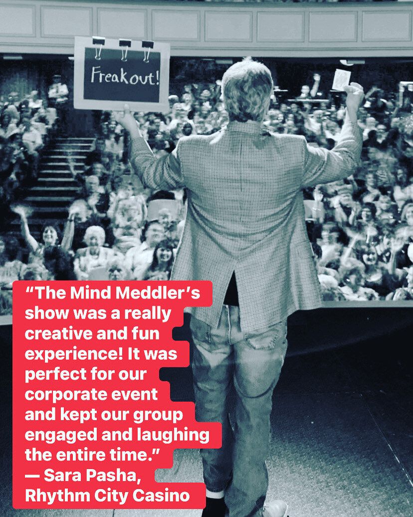 A black and white photo of a man standing in front of a crowd