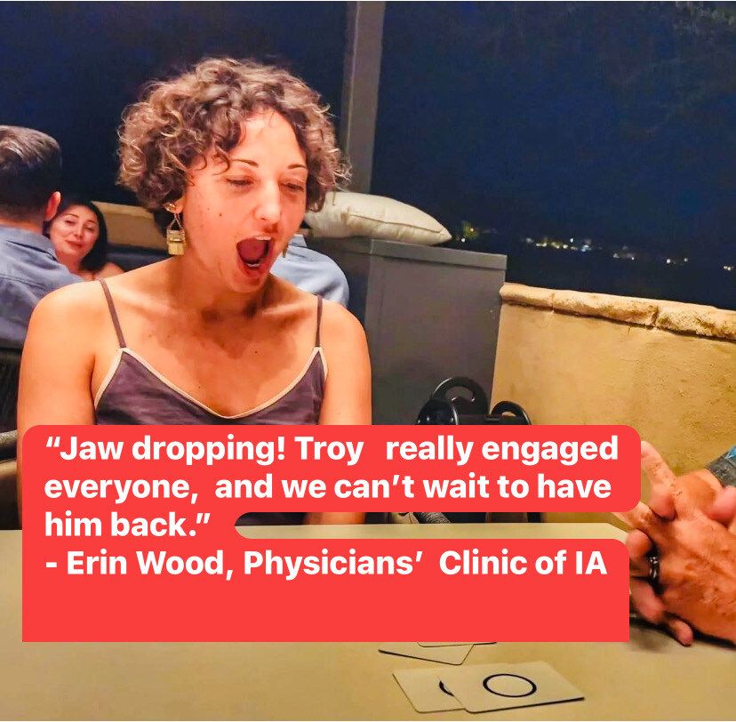 A woman sitting at a table with a quote from erin wood