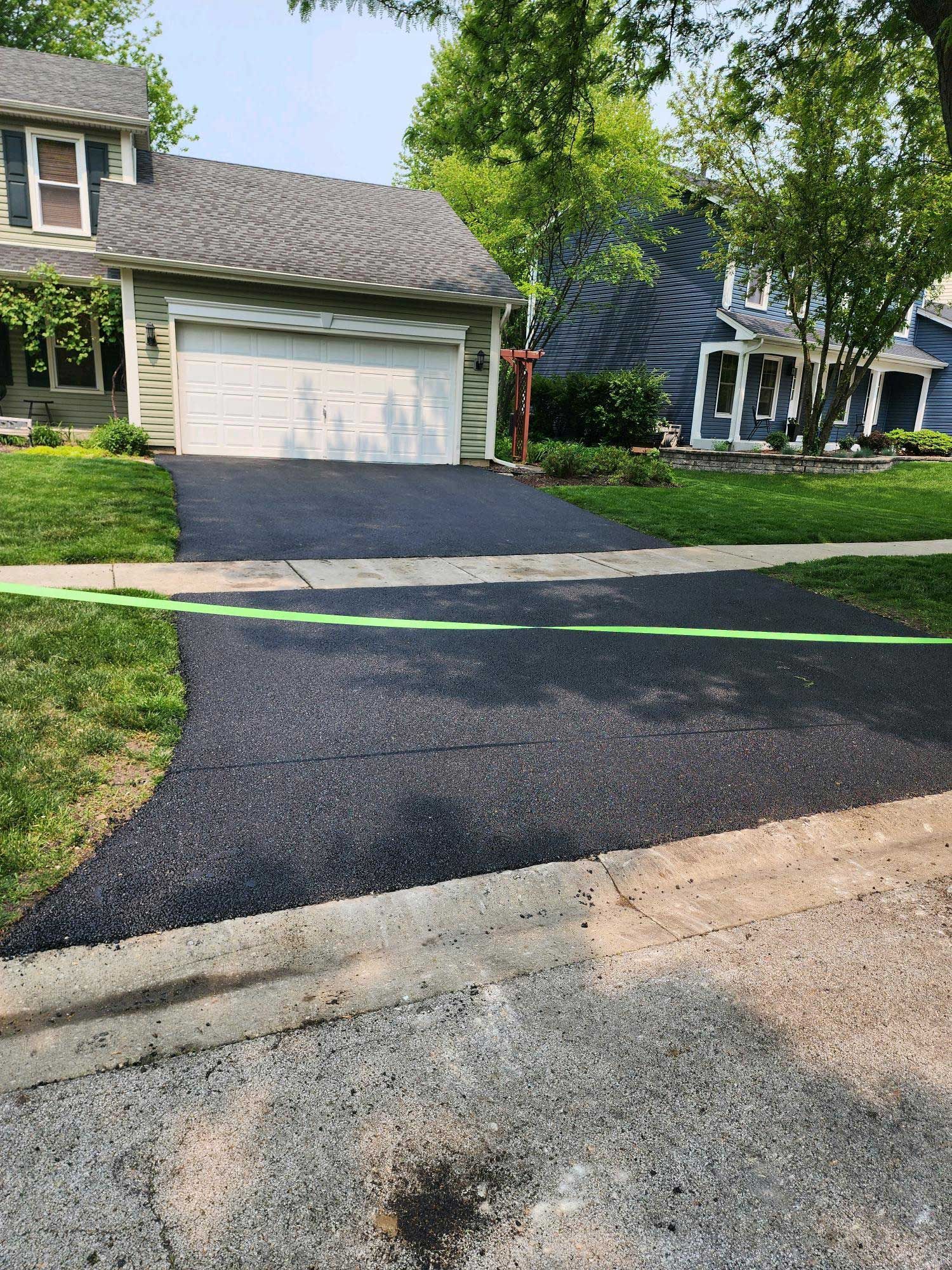 House With White Garage Door — Plainfield, IL — Pro Blacktop Paving