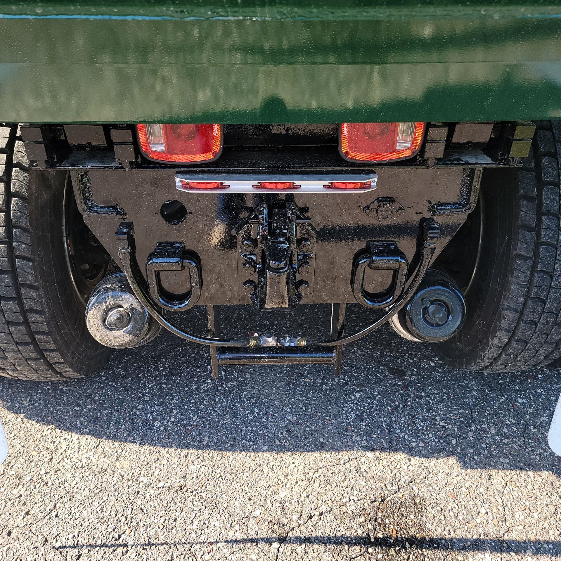 A close up of the back of a green truck