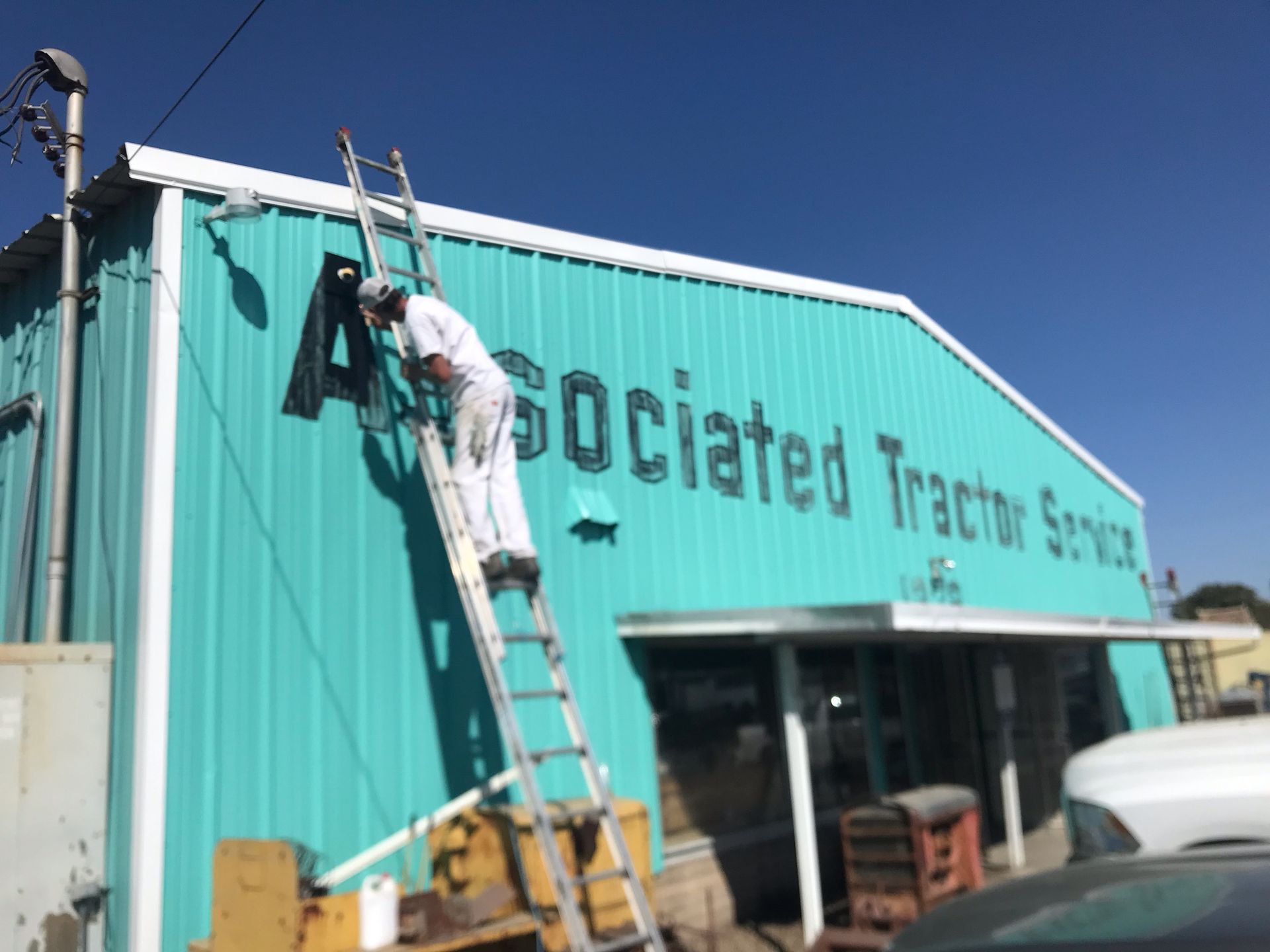Person on ladder painting 