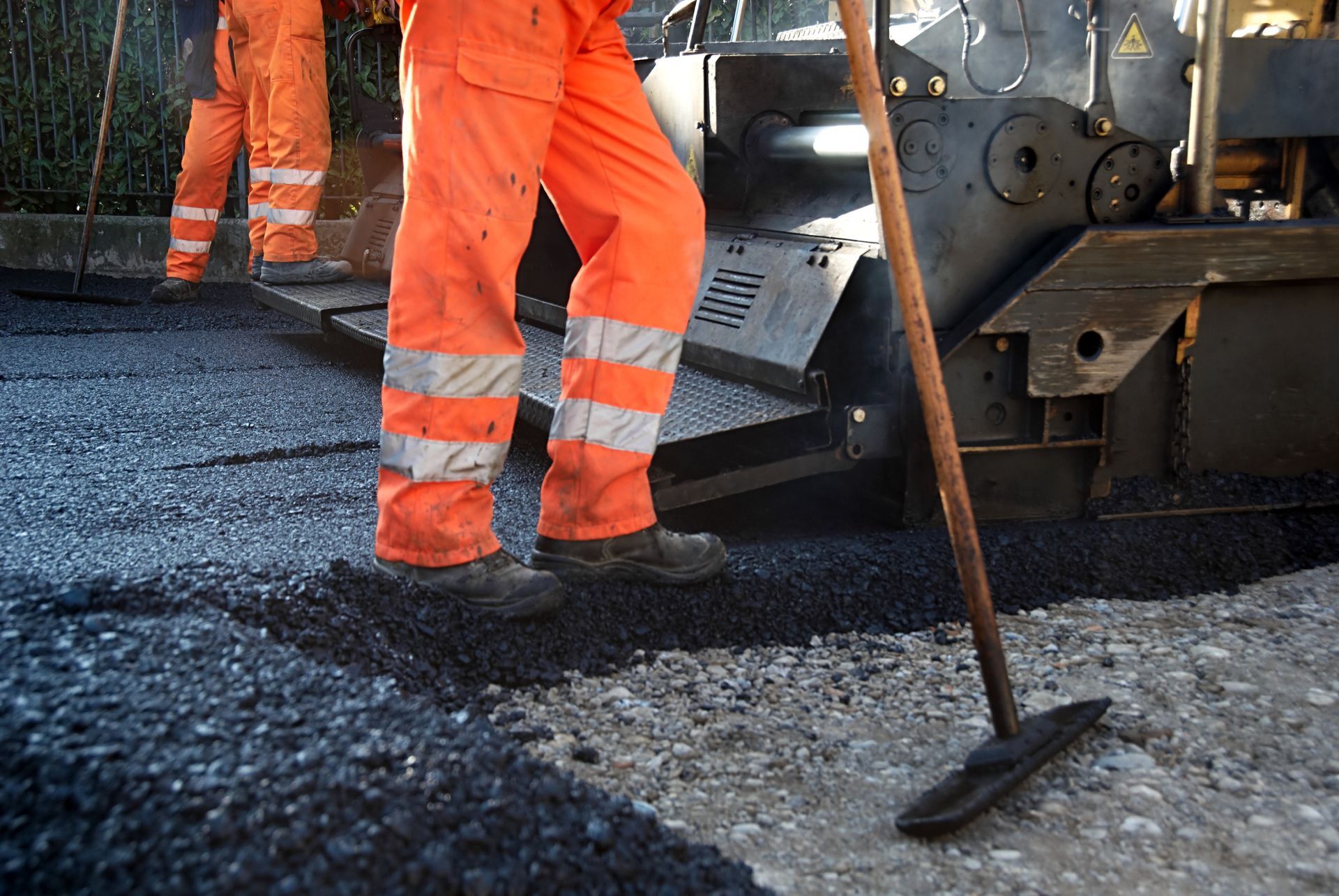 Workers Pouring Asphalt — Menifee, CA — Pacific Asphalt Paving