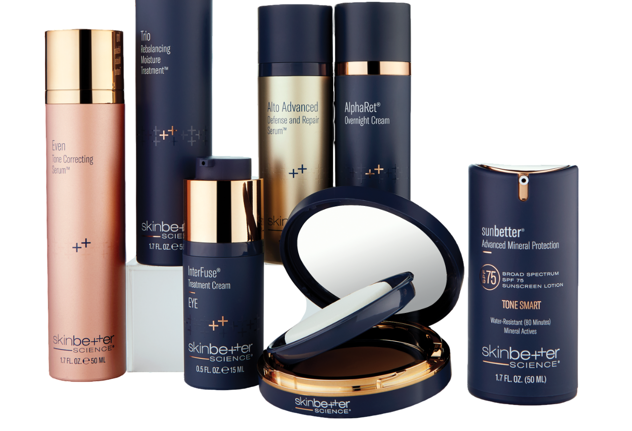 Cosmetic products in navy blue, gold, and rose gold packaging, displayed on a white surface.