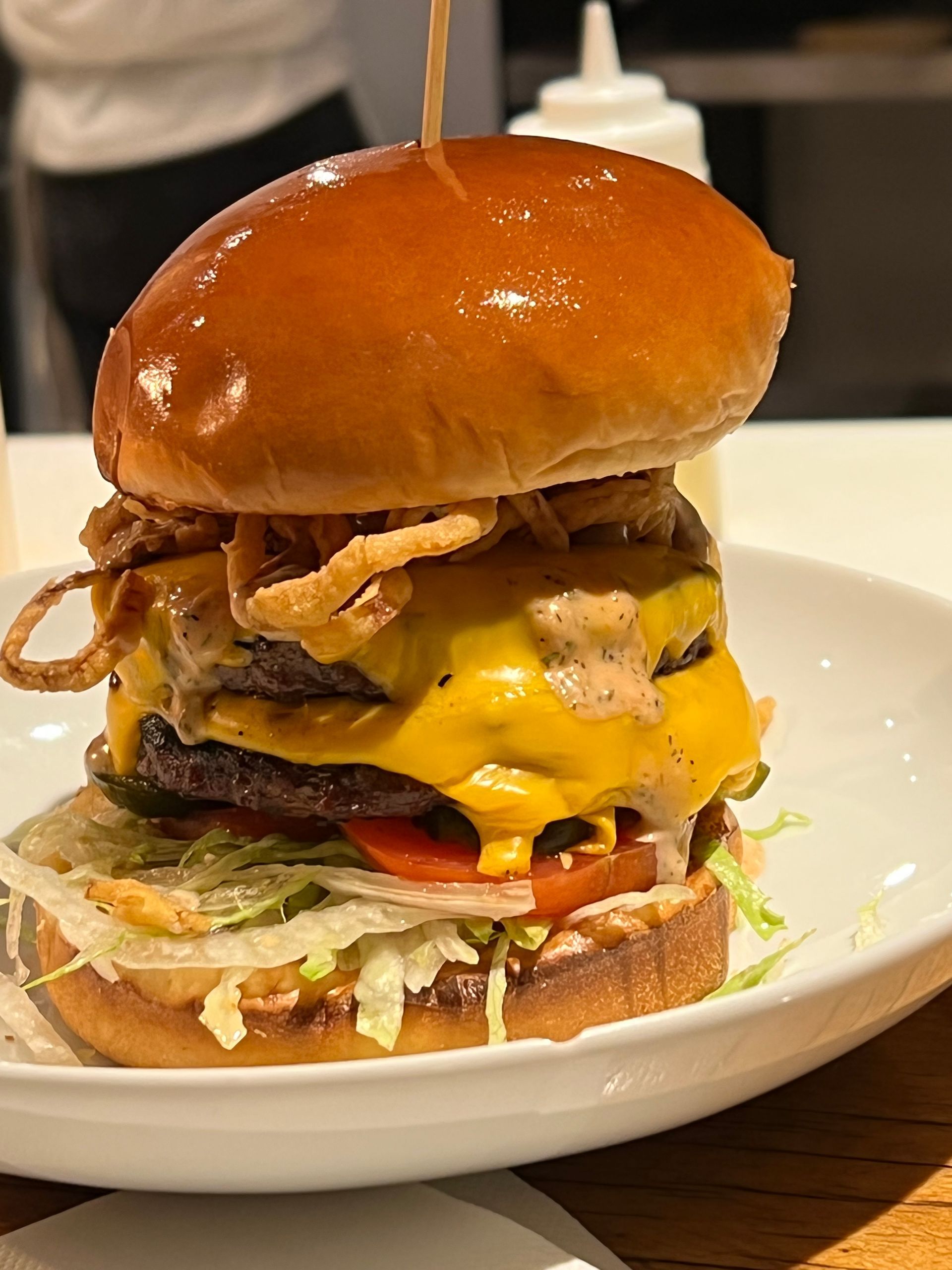 A close up of a hamburger on a white plate