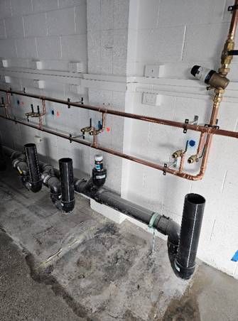 A row of pipes connected to a wall in a room.