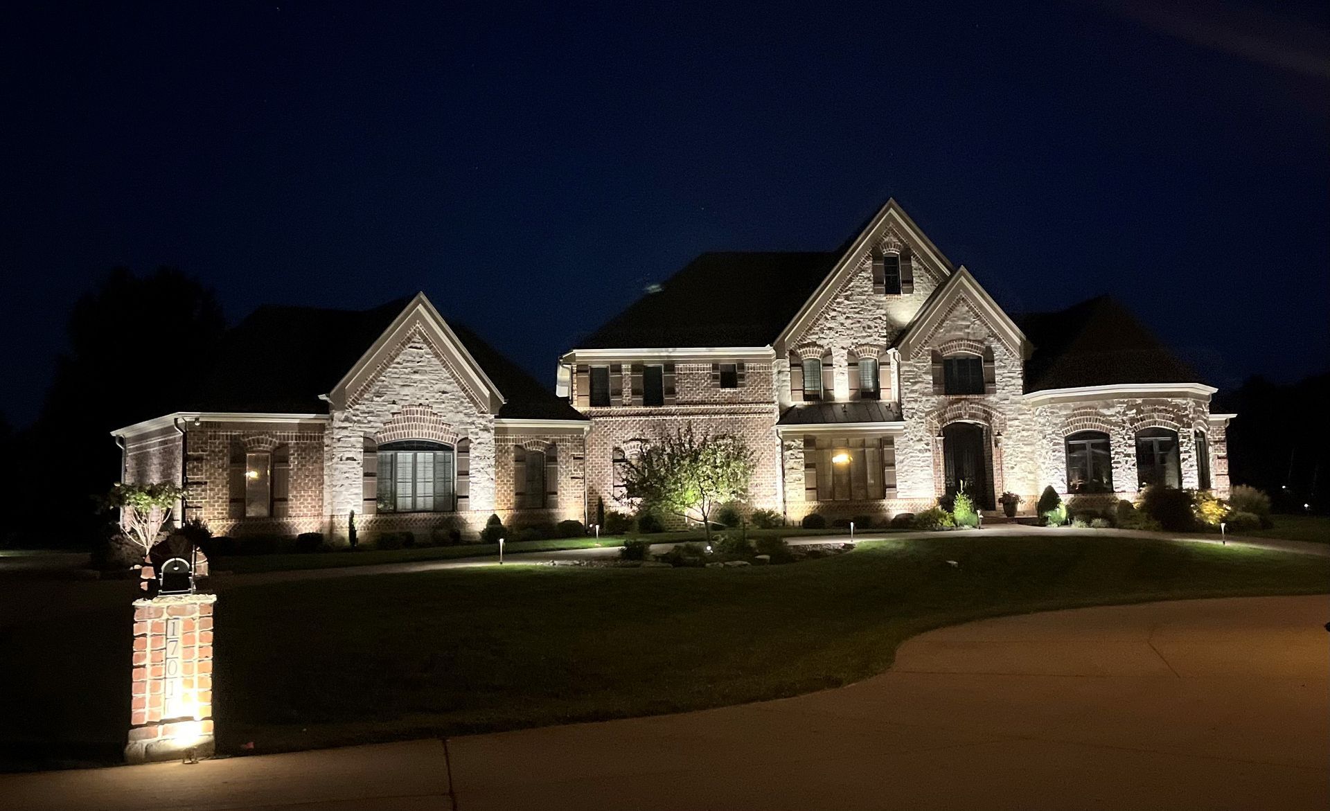 Brick St. Louis residence illuminated with warm architectural uplighting