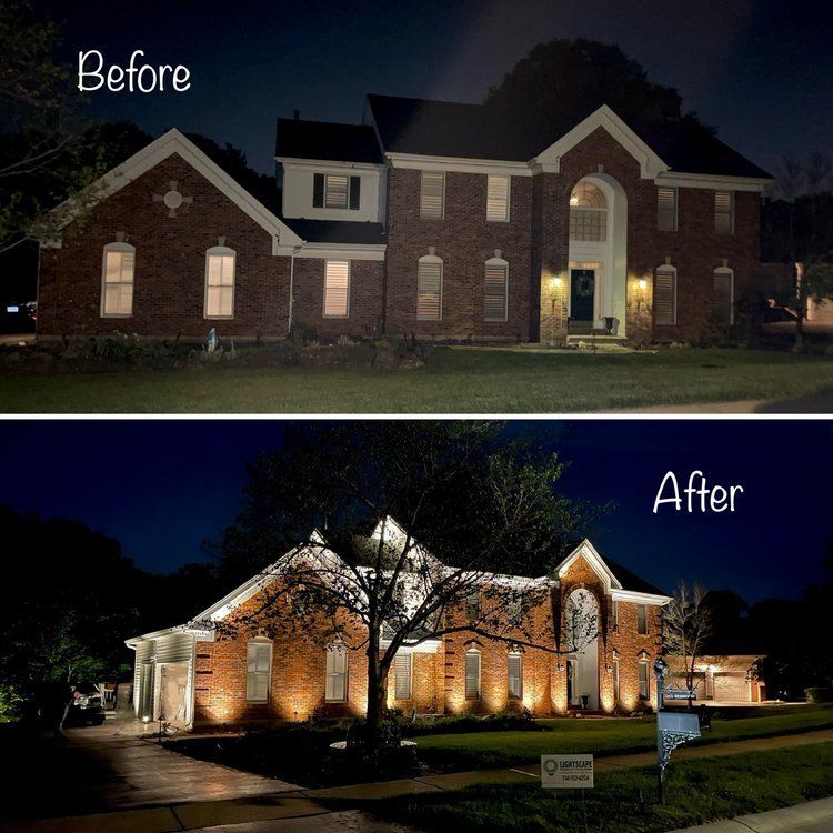Stately brick home with layered tree and facade lighting