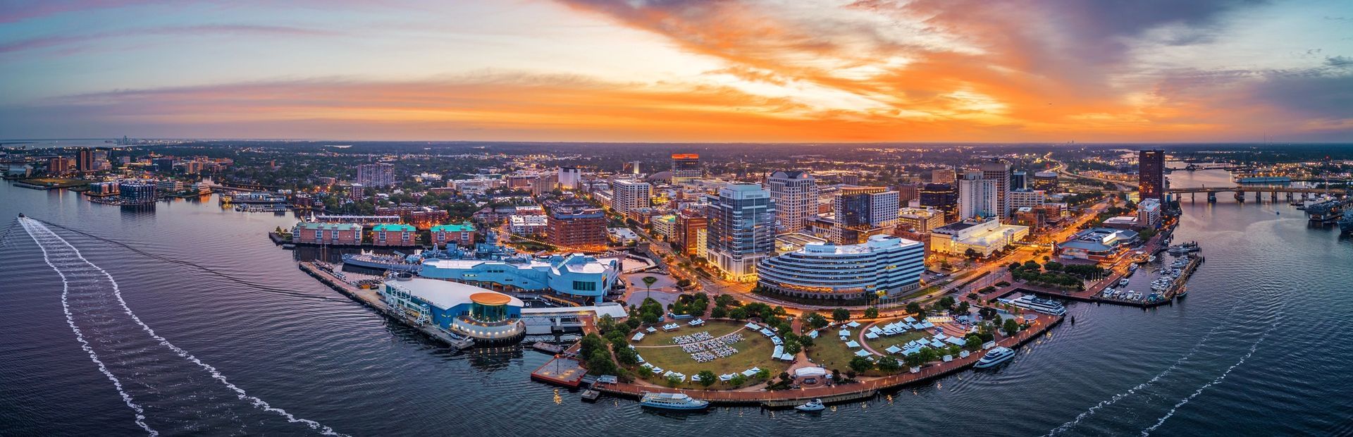 Norfolk, Virginia, USA downtown city skyline from over the Elizabeth River at dusk.