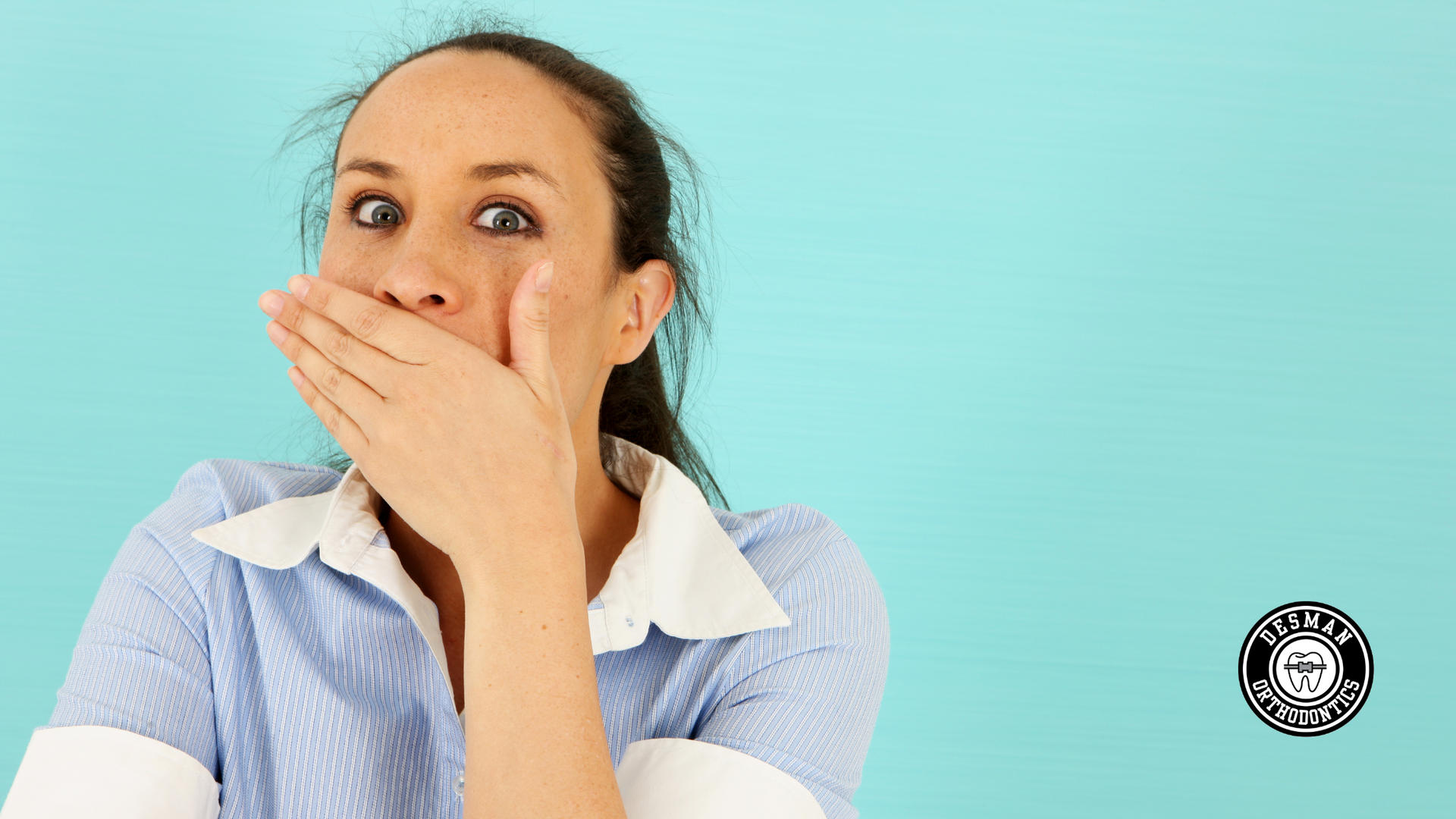 Woman covering her mouth with a surprised expression against a teal background