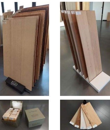 Collage di pannelli campione in legno esposti su supporti e in una scatola, in un allestimento da showroom.