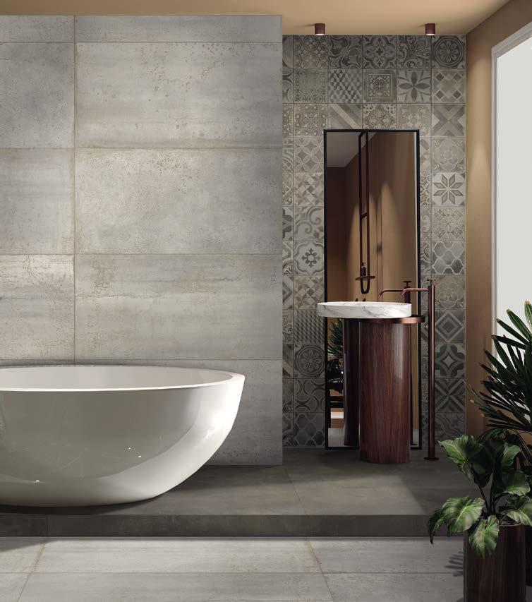 Bagno moderno con vasca freestanding bianca, pareti in pietra, specchio e lavabo a colonna.