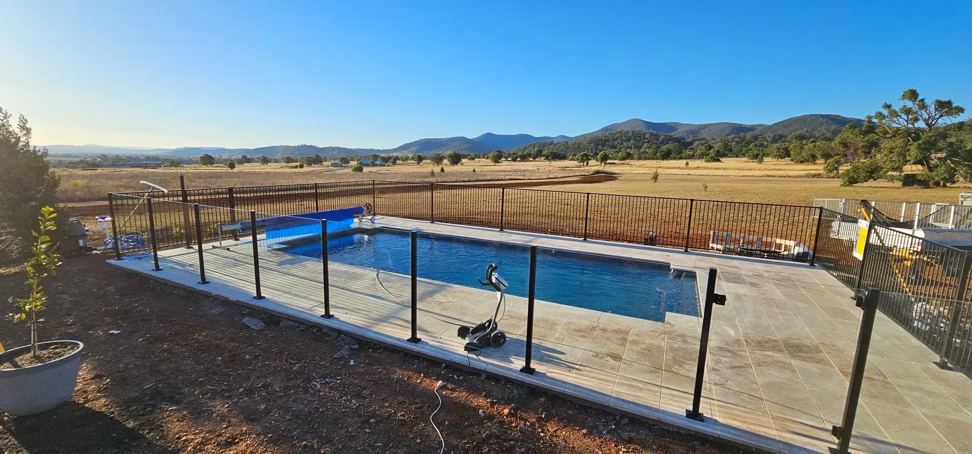 Swimming Pool With a Blue Cover, Surrounded by a Fence — Newcorp Pools In Gunnedah, NSW