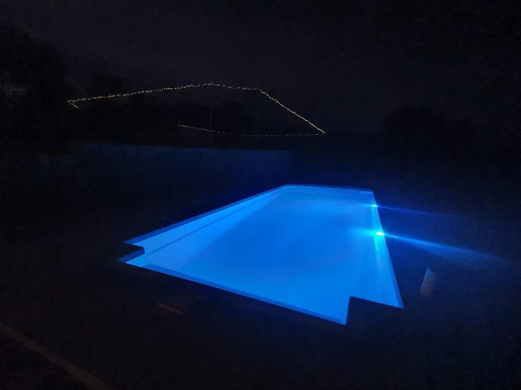 Blue Illuminated Swimming Pool at Night — Newcorp Pools In Moore Creek, NSW
