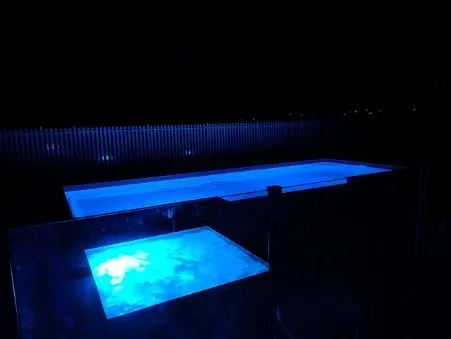 Two Illuminated Blue Pools at Night — Newcorp Pools In Moore Creek, NSW