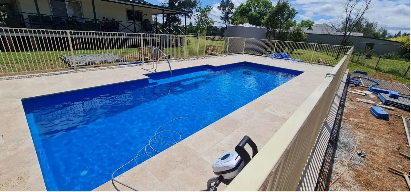 A Rectangular Swimming Pool Filled With Blue Water Surrounded by Concrete — Newcorp Pools In Moore Creek, NSW