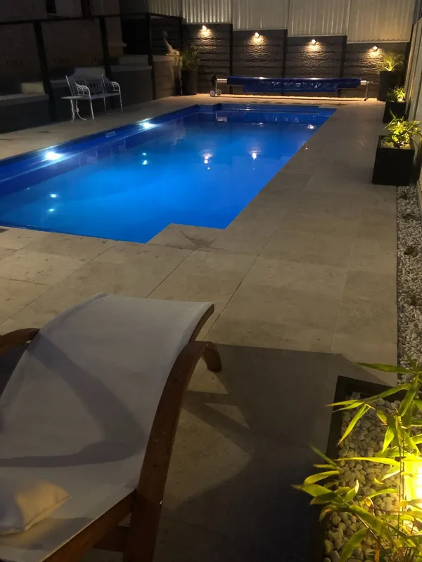 Night View of a Swimming Pool With Blue Water — Newcorp Pools In Moore Creek, NSW