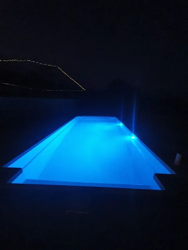Blue-lit Rectangular Swimming Pool at Night — Newcorp Pools In Moore Creek, NSW