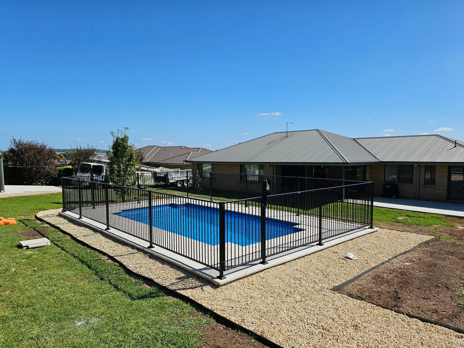 Rectangular Pool Surrounded by Black Fence — Newcorp Pools In Moore Creek, NSW