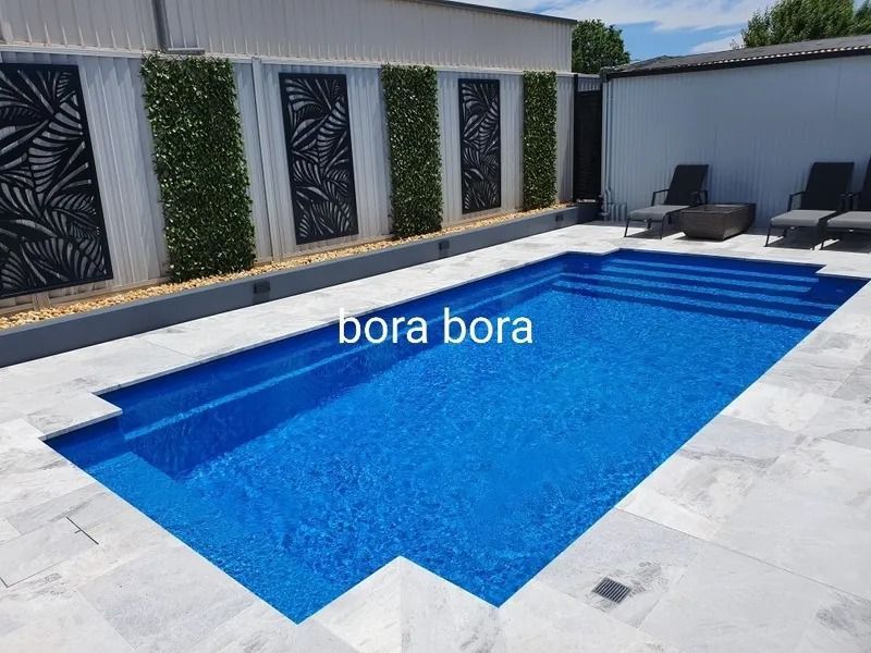 Blue Rectangular Pool With Steps and Decorative Wall — Newcorp Pools In Moore Creek, NSW