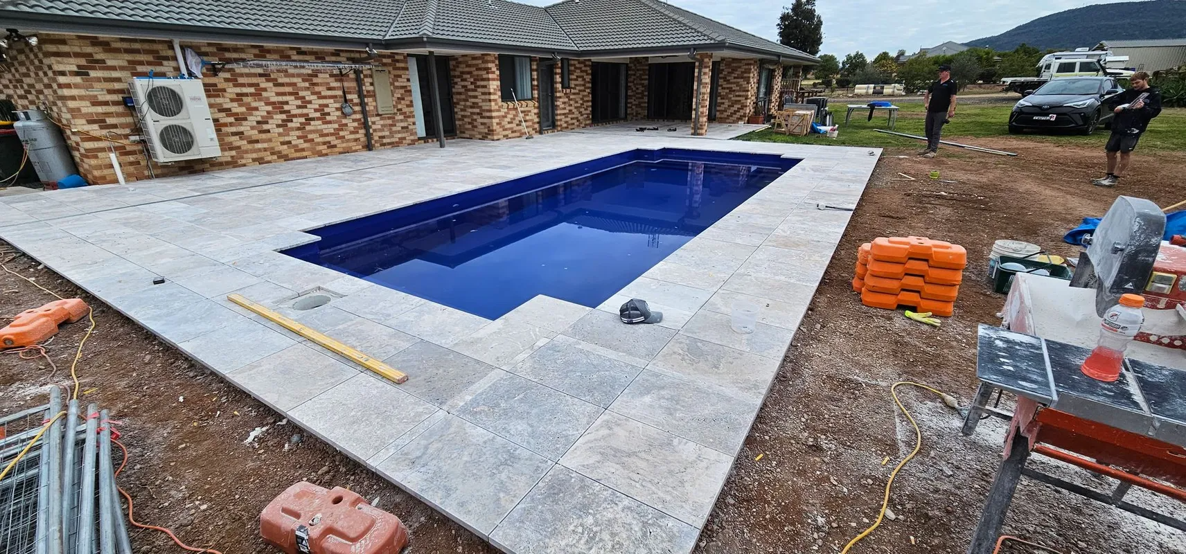 Pool Under Construction With Stone Patio — Newcorp Pools In Moore Creek, NSW