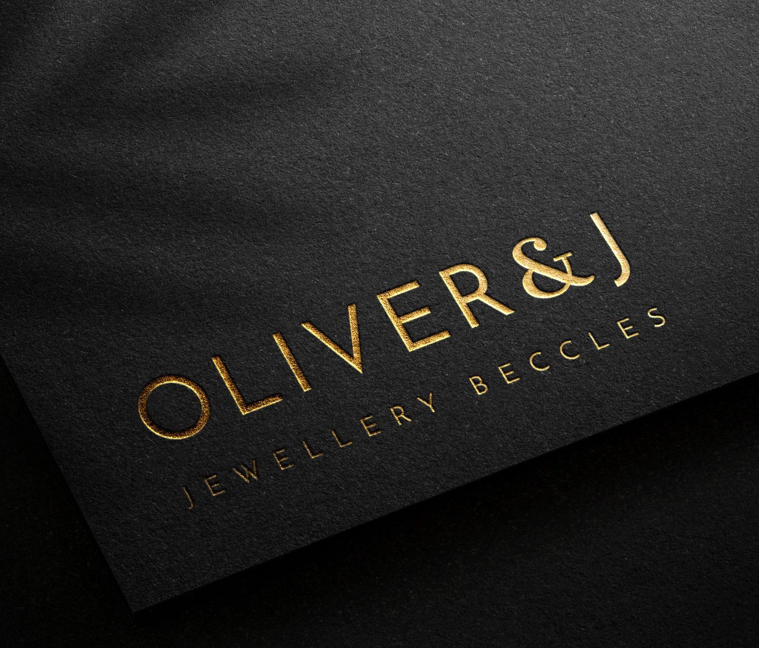 A black piece of paper with the words oliver & j written on it