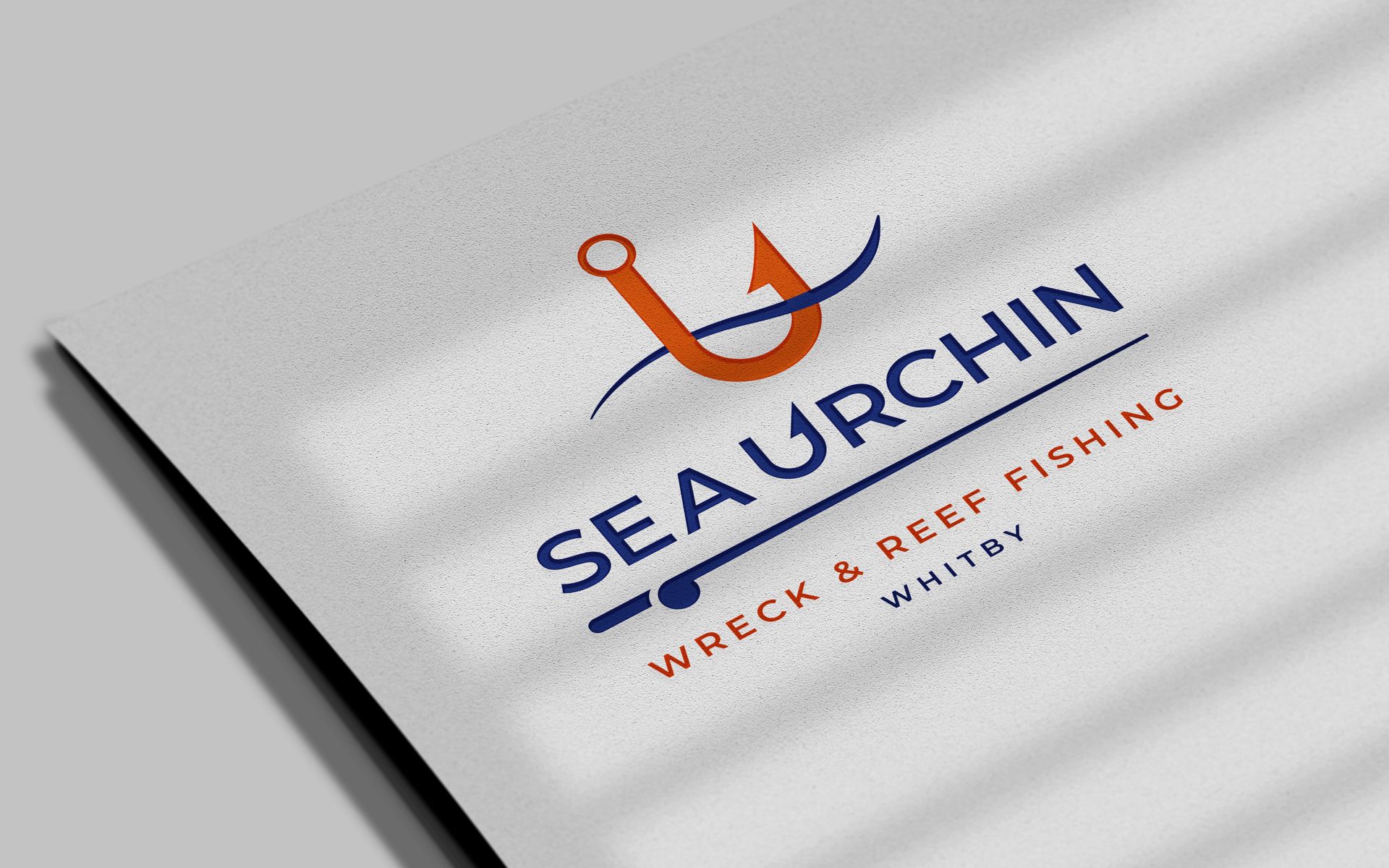 The logo for sea urchin wreck & reef fishing is on a piece of paper.