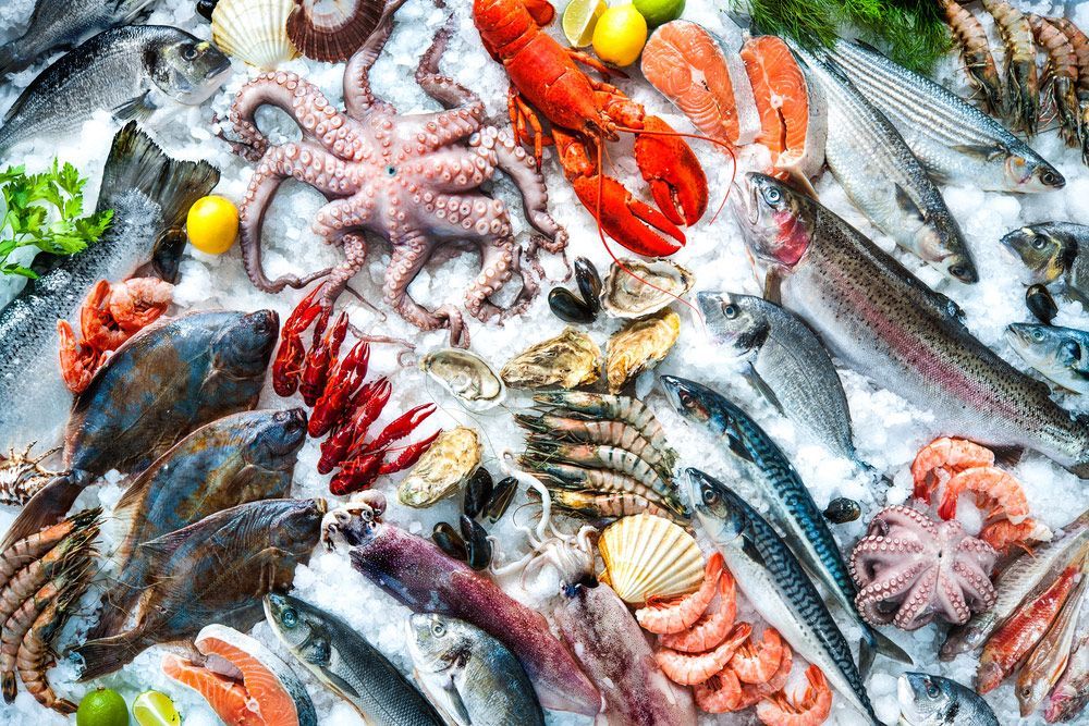 A variety of seafood is sitting on top of ice.