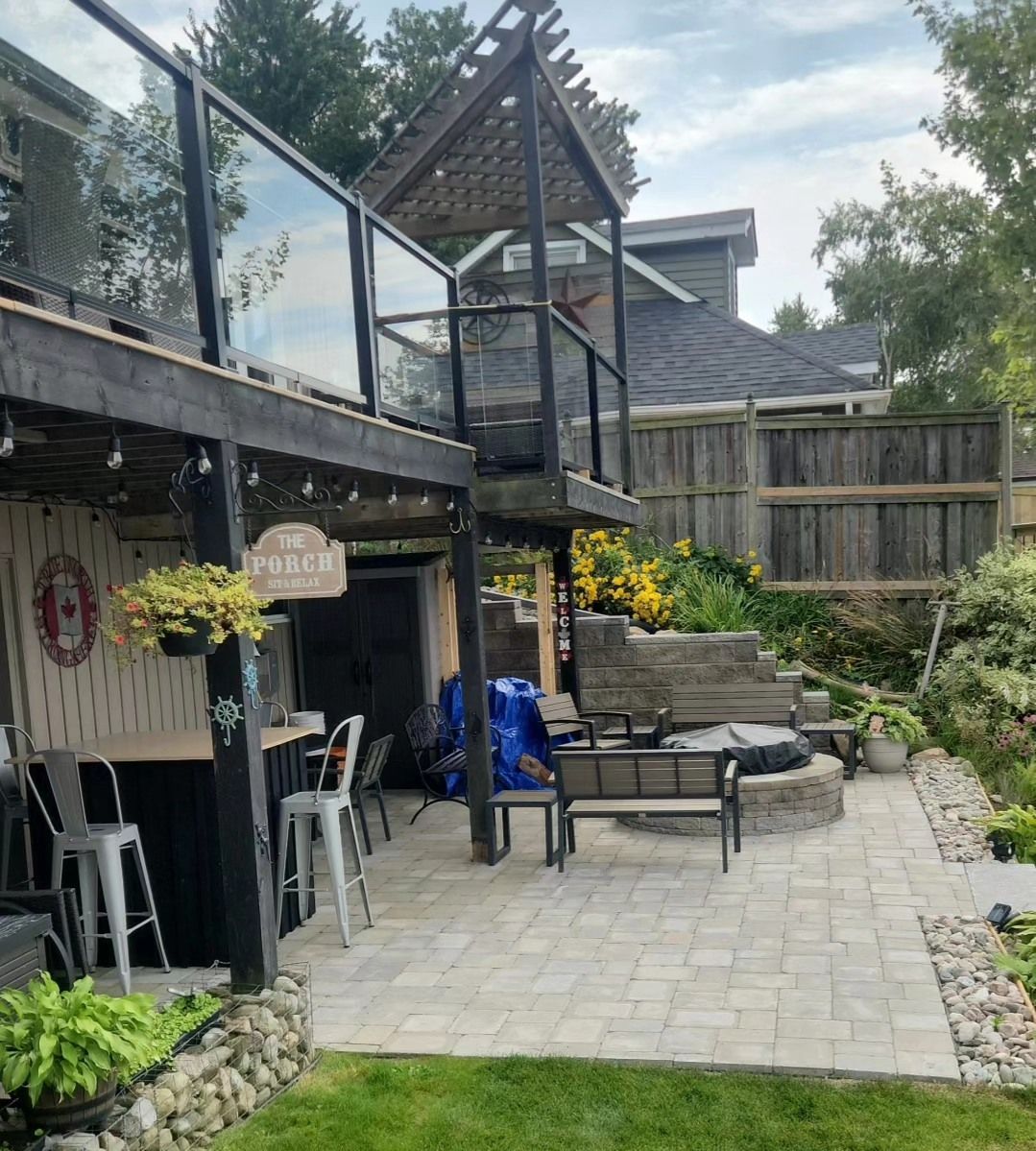 A patio with a fire pit and a sign that says welcome