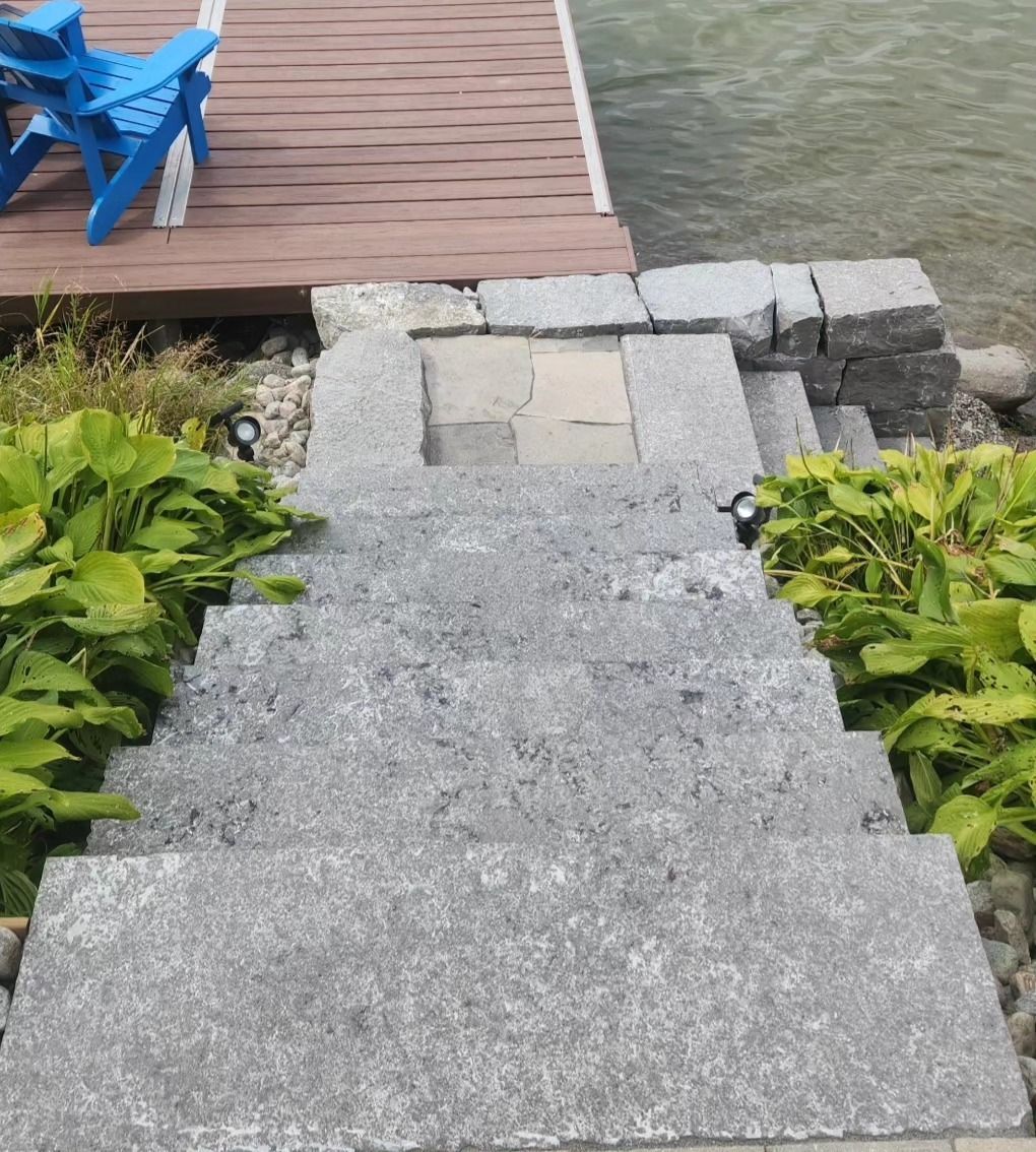 A set of stairs leading to a dock next to a body of water