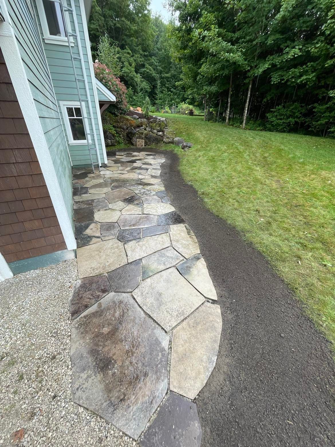 A brick walkway leading to the front door of a house