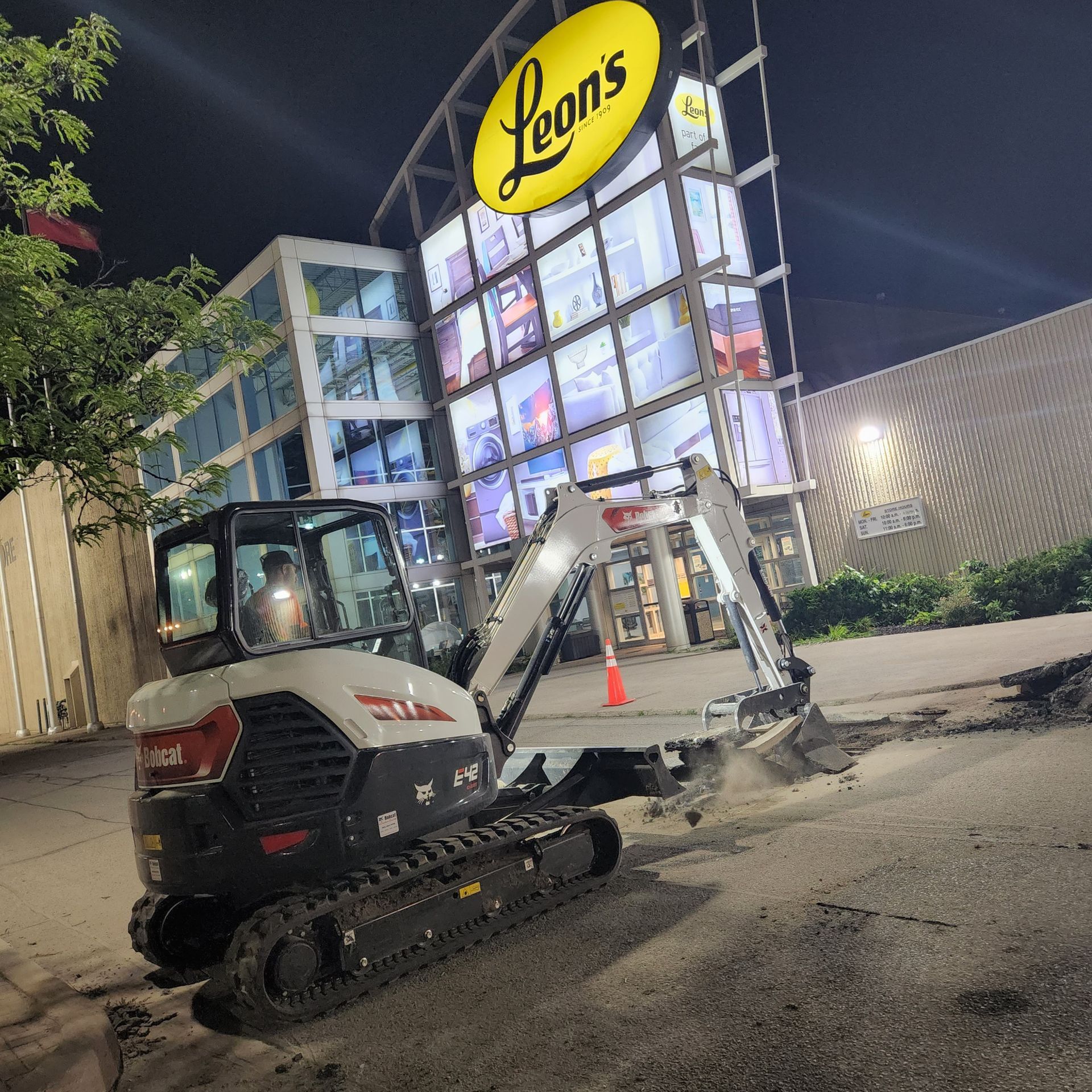 A bulldozer is parked in front of a leon 's restaurant