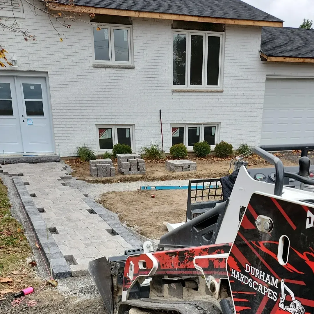 A house with a patio and a sidewalk in front of it