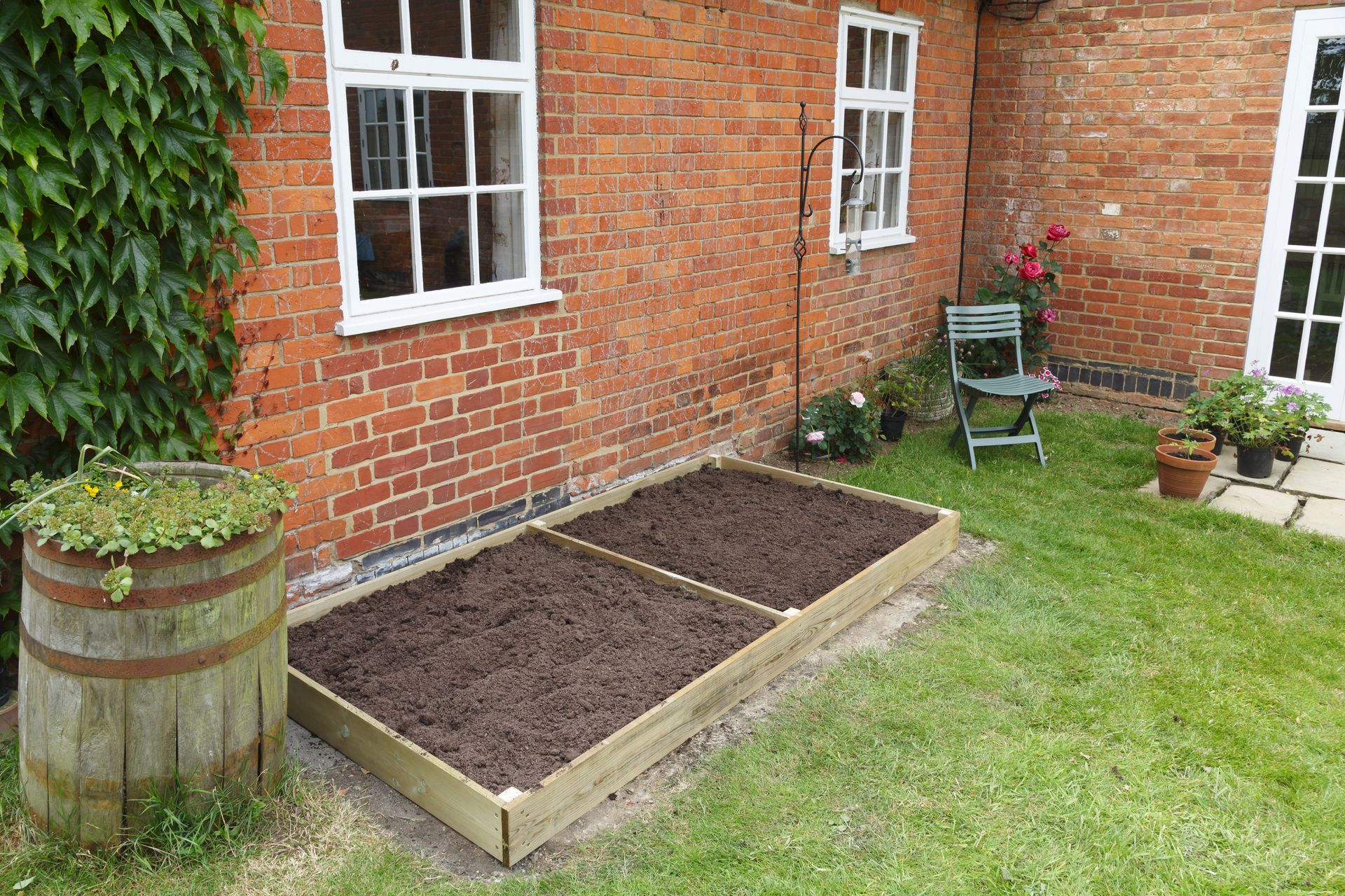 A brick house with a garden in front of it.