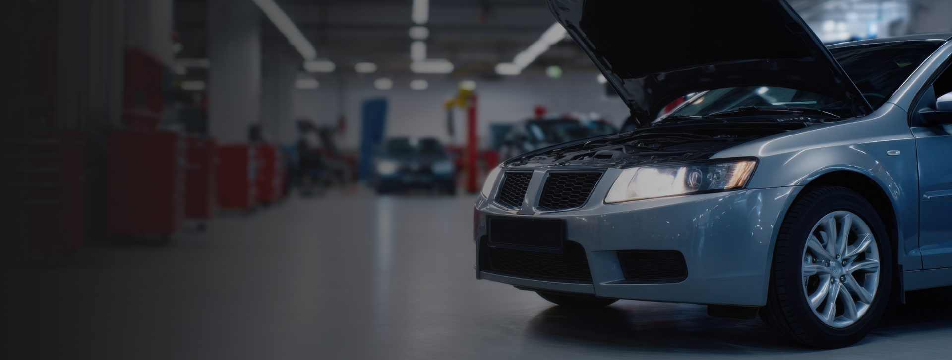 Car with hood up in auto repair garage | Manny's Auto