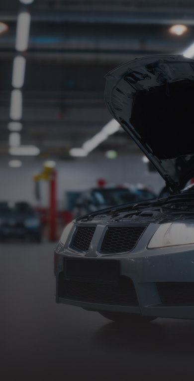 Car with hood up in auto repair garage | Manny's Auto