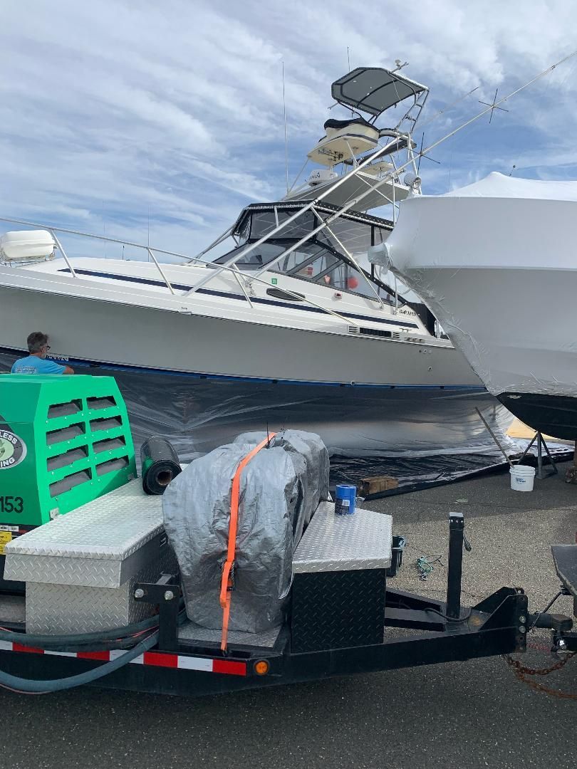 Removing layers of bottom paint on a boat on Long Island