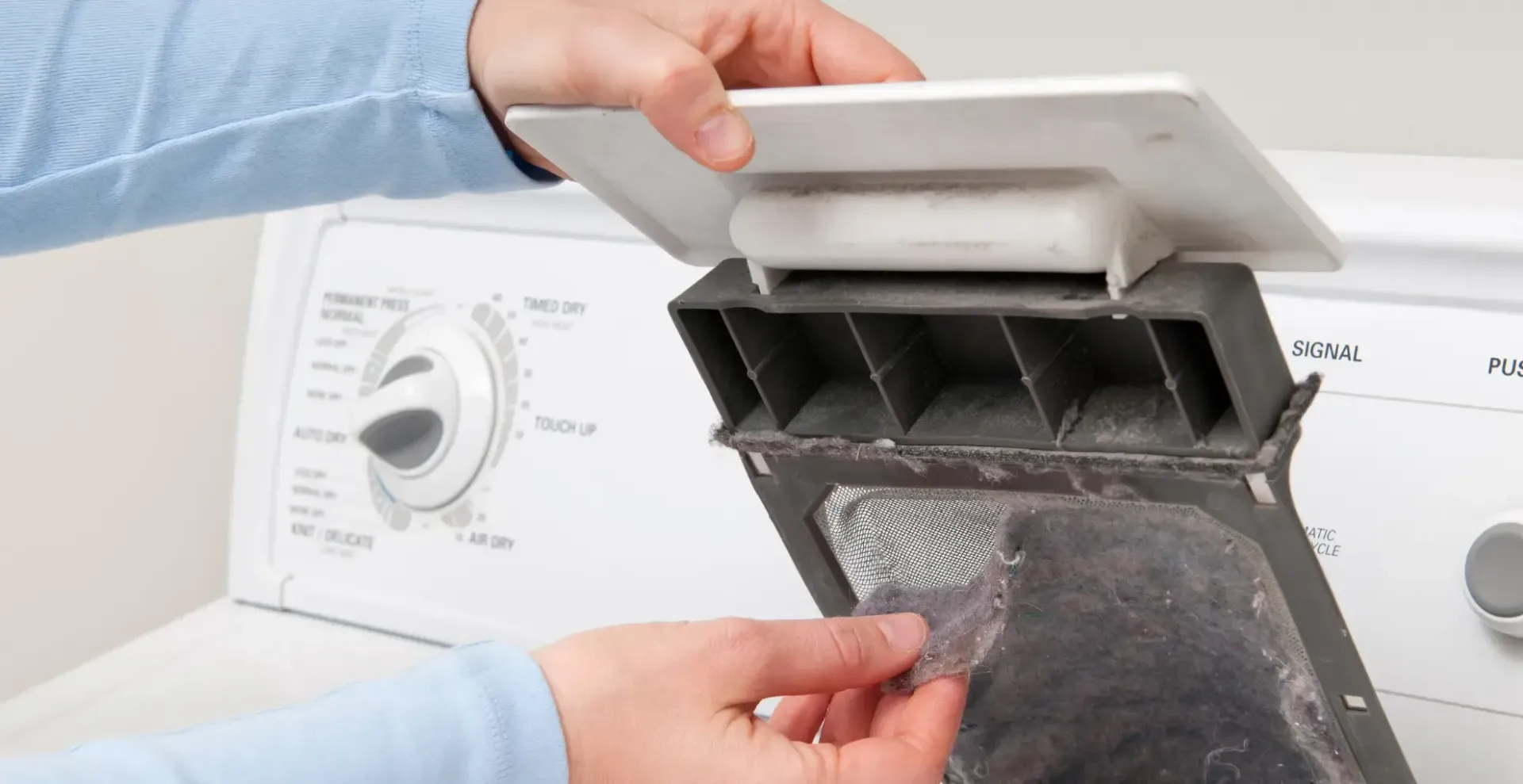 Love's Dryer Vent Cleaning - person is cleaning a lint filter on a dryer.
