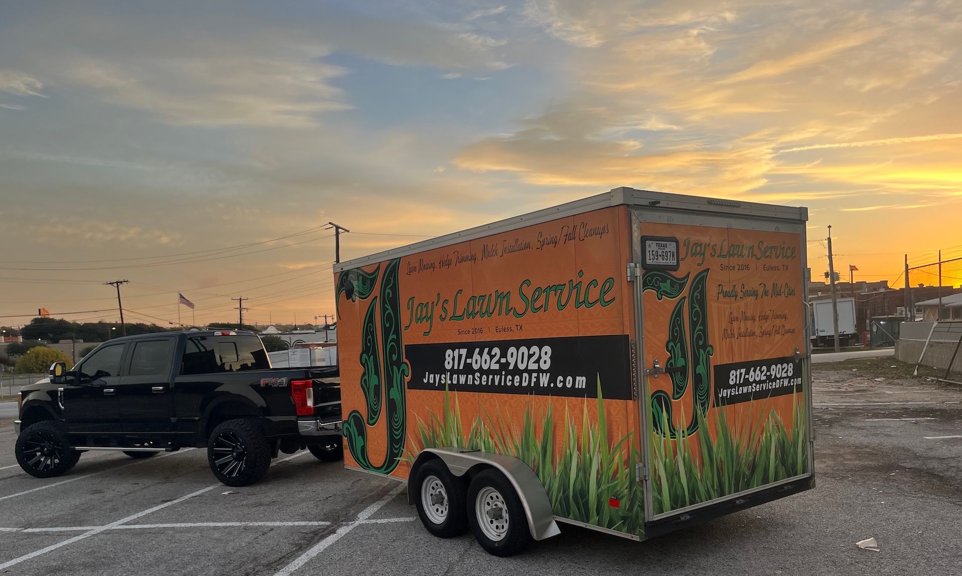 Black truck towing a trailer with 