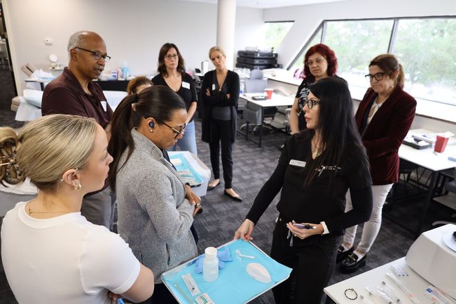 An ESI trainer talking to medical esthetic students at ESI