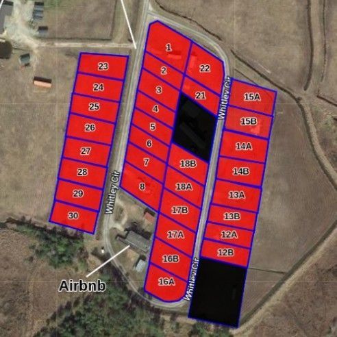Colored aerial plot map with numbered red and blue lots, labeled Airbnb near the lower left.