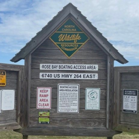 North Carolina Wildlife Resources sign for Rose Bay Boating Access Area on a wooden kiosk