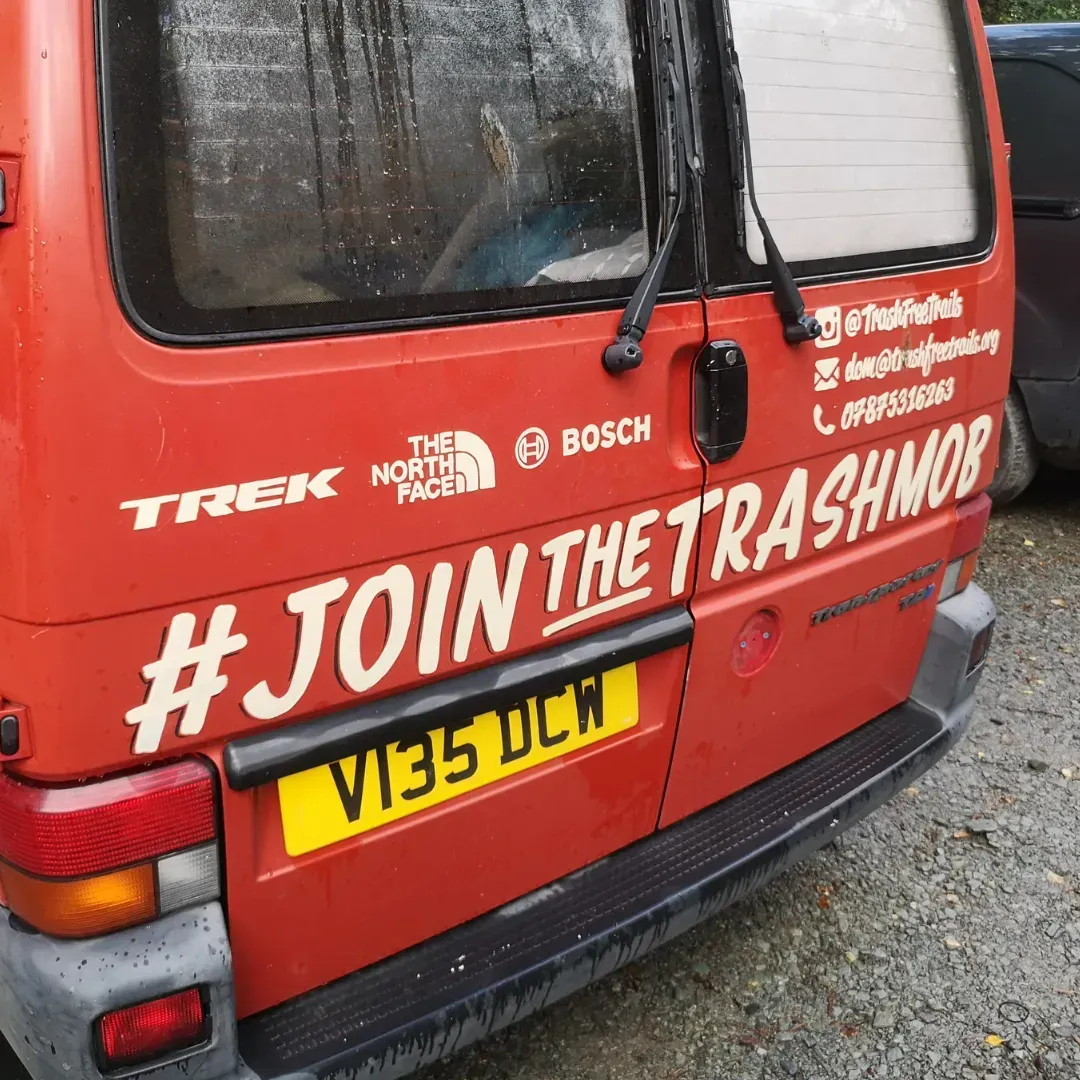 A red van with # join the trashmob written on it