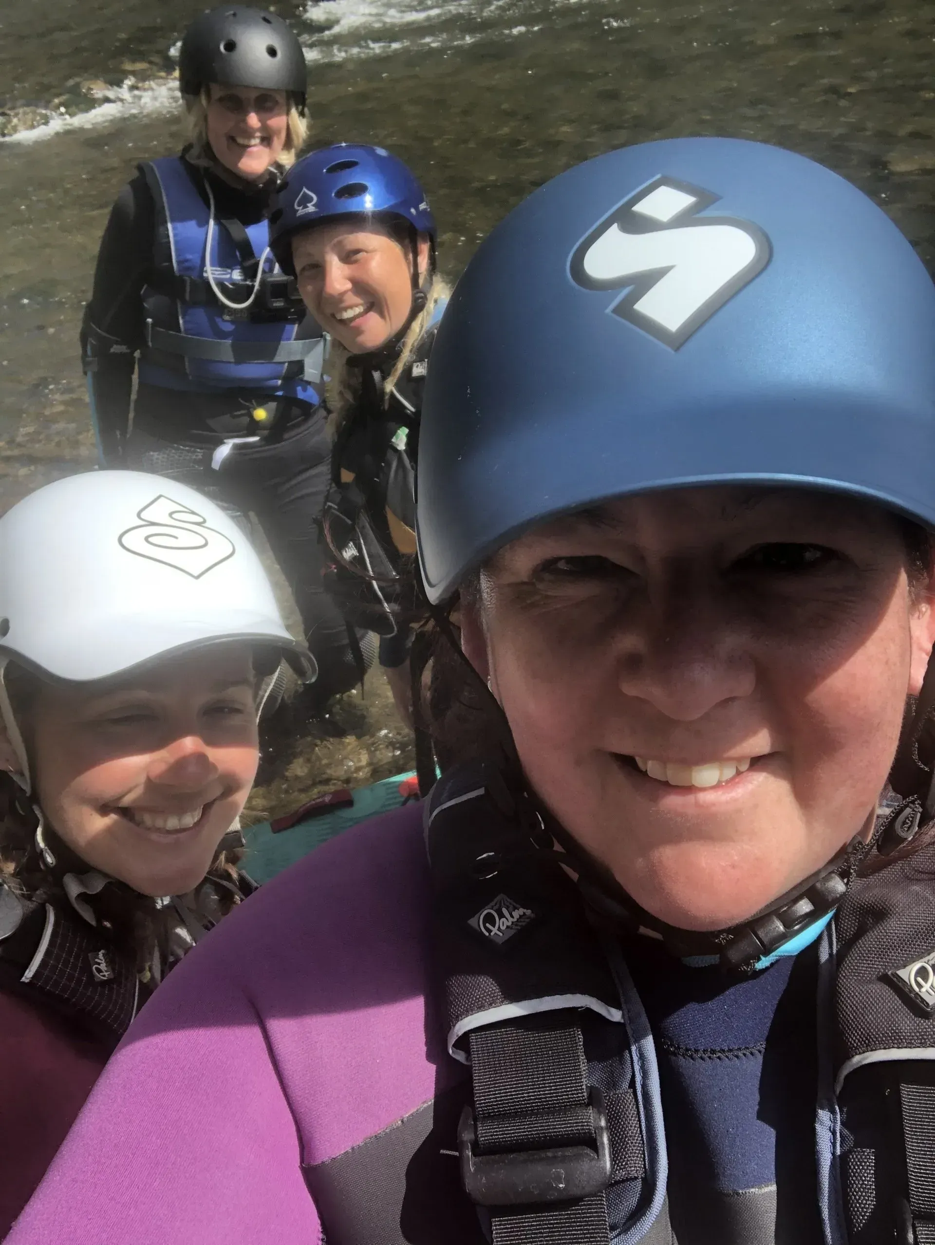 A woman wearing a blue helmet with the letter s on it
