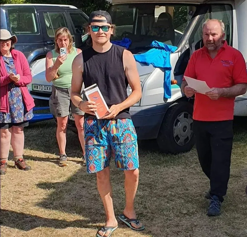 A group of people are standing in front of a van