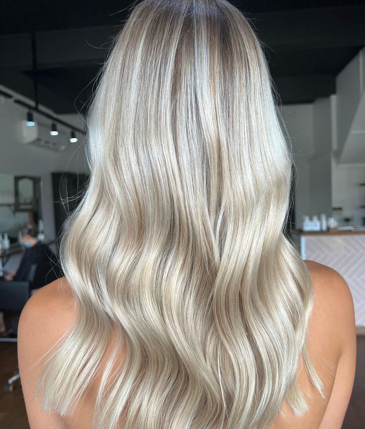 Blonde hair with crimped texture styled in loose waves.