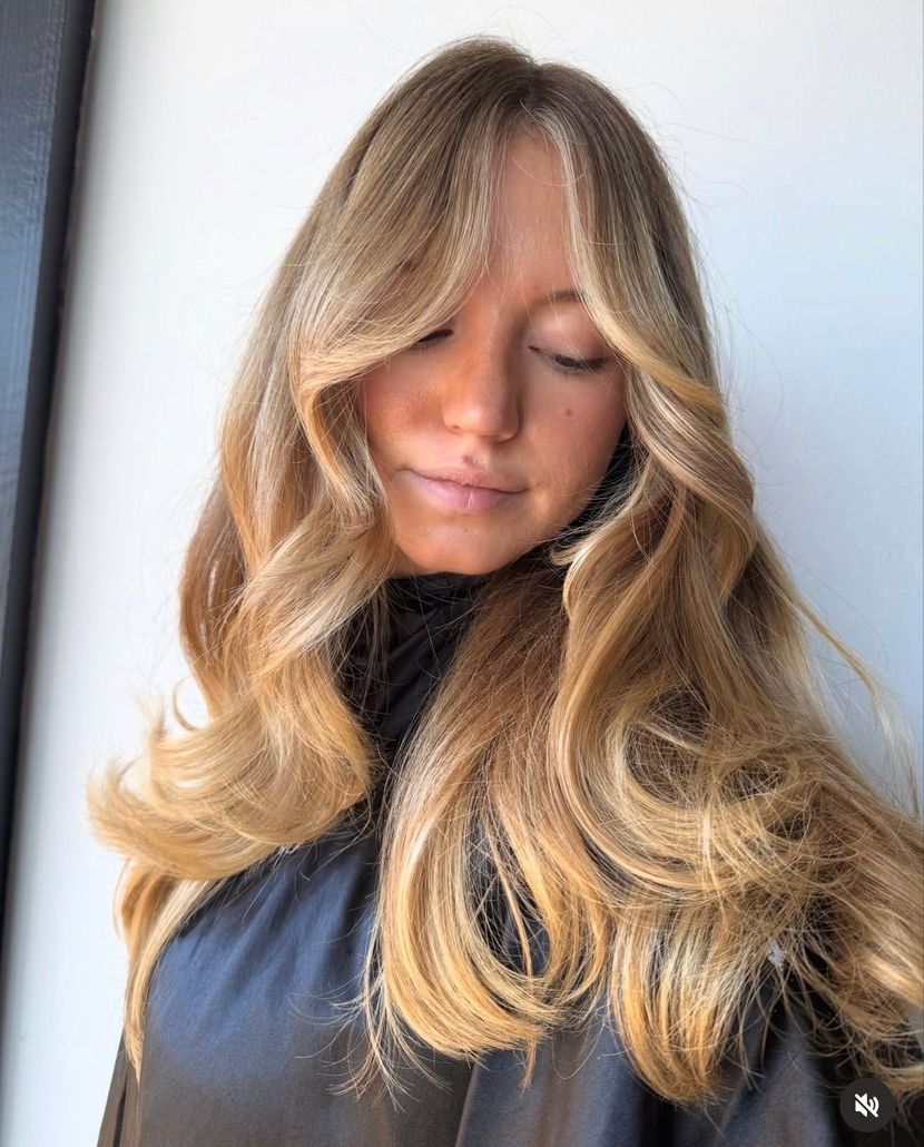 Blonde hair with streaks and layers. Woman in a hair salon.
