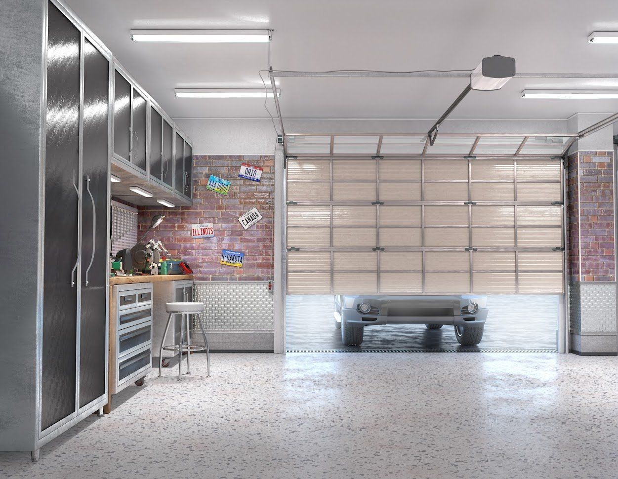 A well-lit garage with cabinets, workbench, open garage door, and a car inside.