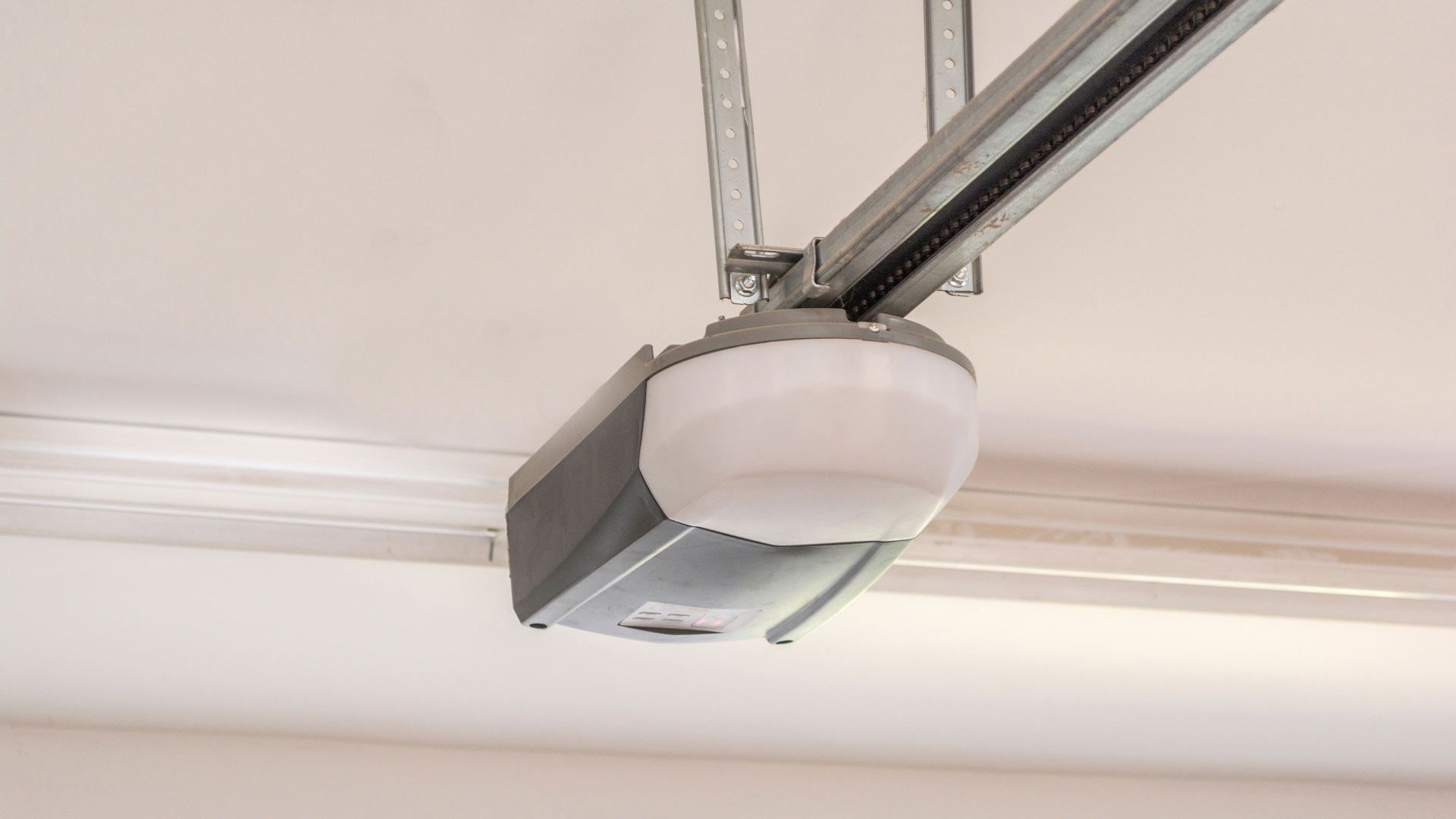 Automatic garage door opener motor on the ceiling.