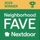 Round “Proud Community Sponsor” plaque with multiple logos on a red textured background