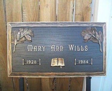Wooden memorial plaque for Mary Ann Wills, 1928–1984, with engraved leaves and open book